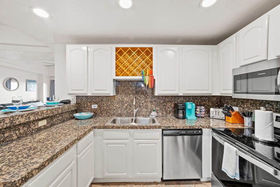 Prepare meals with ease in this beautifully updated kitchen with tile backsplash and pantry space.