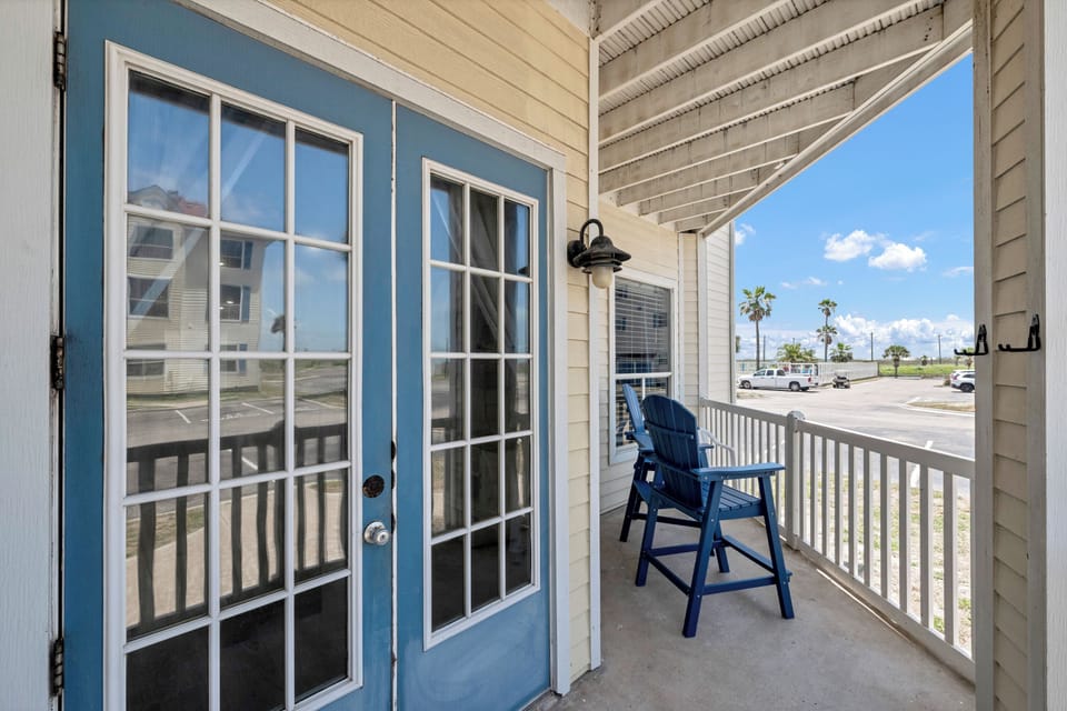 Step onto your private balcony and settle into the blue chair for morning coffee with views of palm-lined streets.