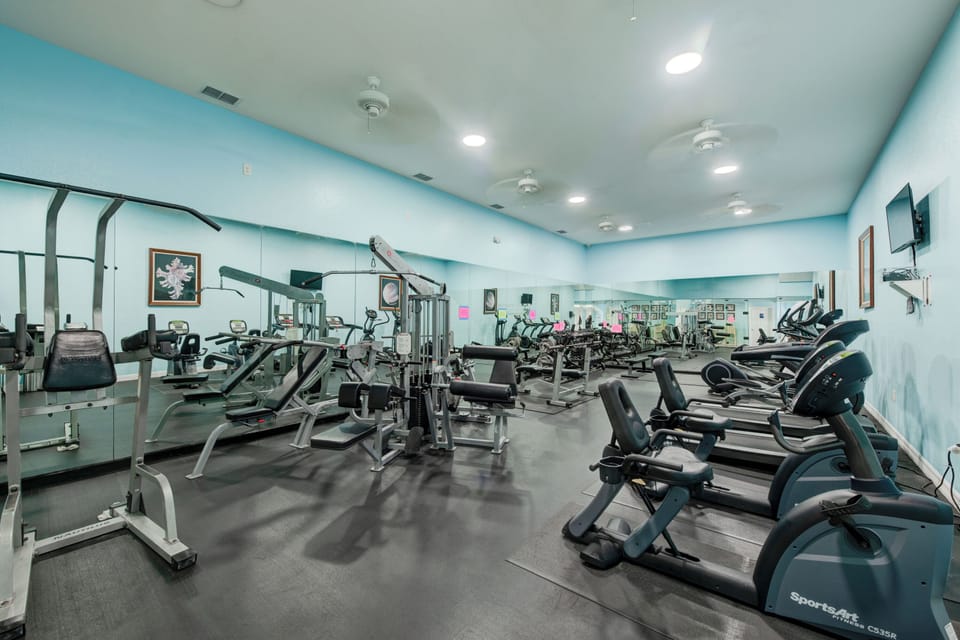 Your modern fitness center awaits with cardio machines, strength equipment, and motivational energy to power through your workout routine.
