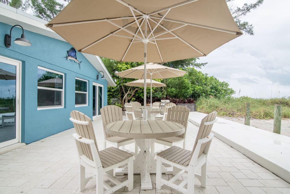 High quality outdoor furniture with tables, chairs, & umbrellas.