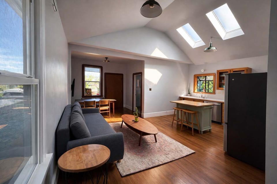 A nice living room with comfortable sofa and warm wood floors.