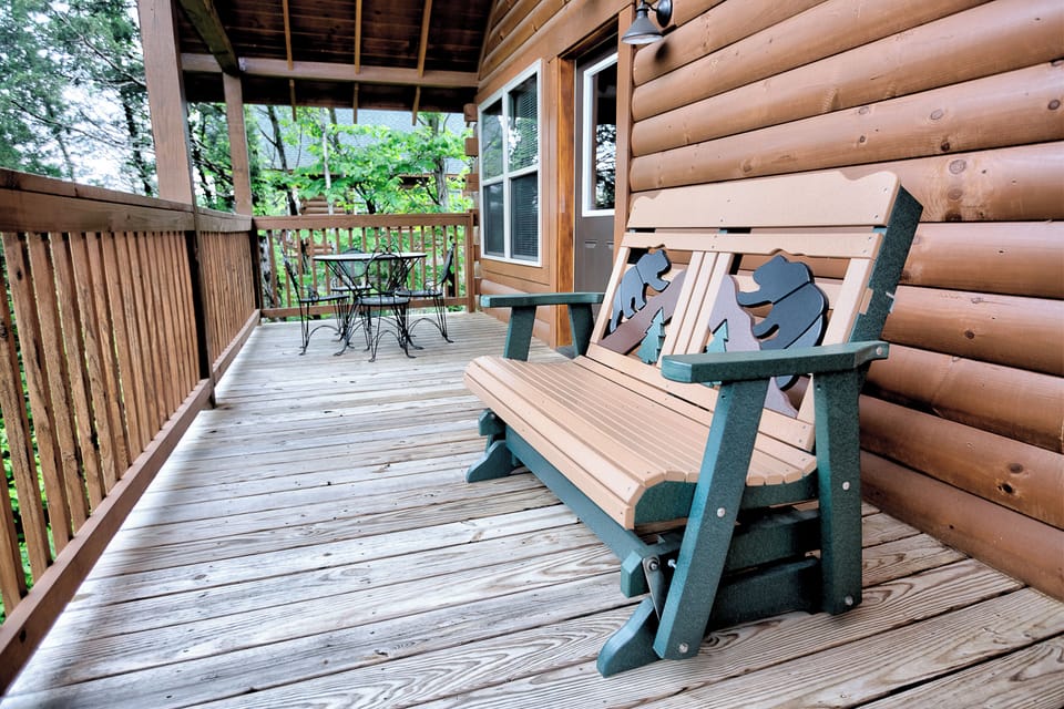 Main level balcony overlooking a tree view with mountains in the distance. 