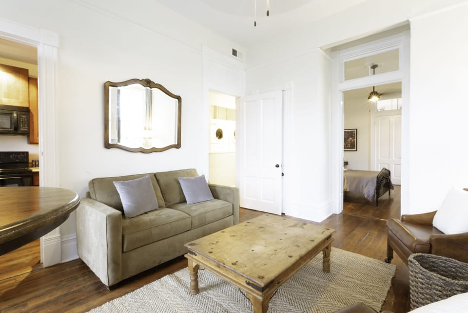 The cozy living room features a smart TV and bar dining table for two.