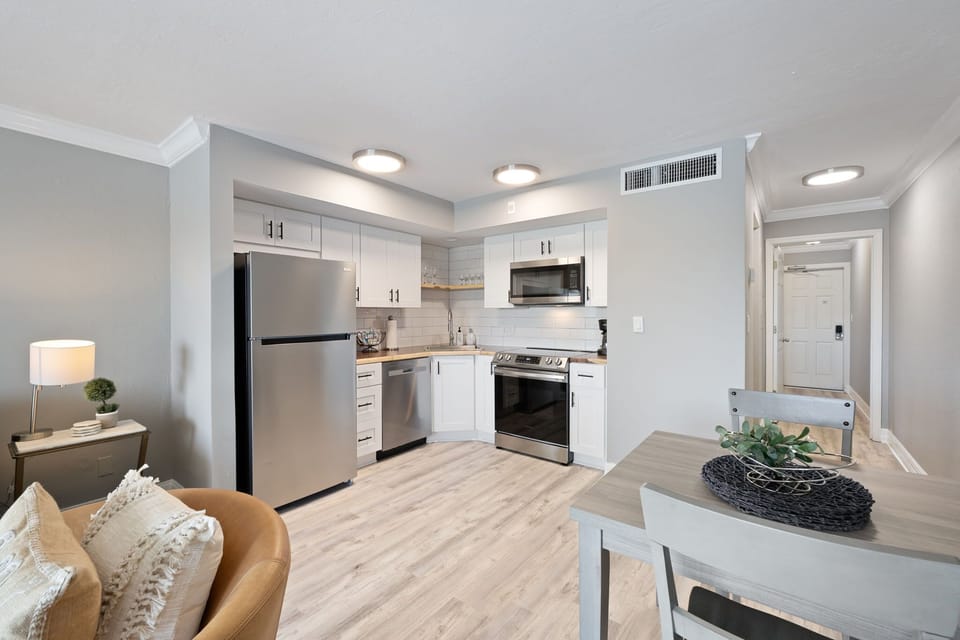 Expansive living room with full kitchen overlooking marina