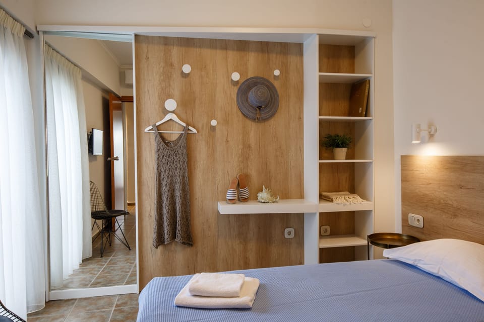 Family Room, 2 Bedrooms, Partial Sea View | Minibar, in-room safe, desk, iron/ironing board