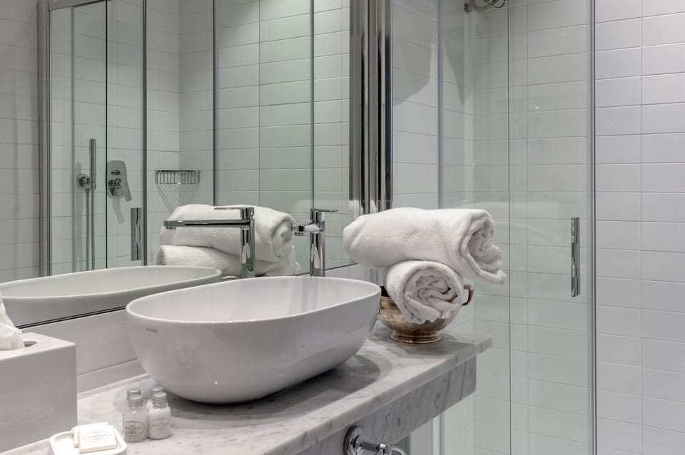 Designer toiletries, hair dryer, bathrobes, slippers