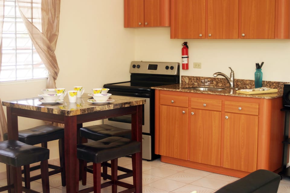 Two Bedroom Condo Queen Deluxe | Private kitchen | Full-size fridge, microwave, stovetop, coffee/tea maker