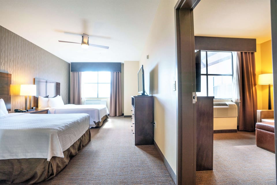 Suite, 2 Queen Beds, Accessible, Bathtub | Living area | 32-inch LCD TV with cable channels, TV, DVD player