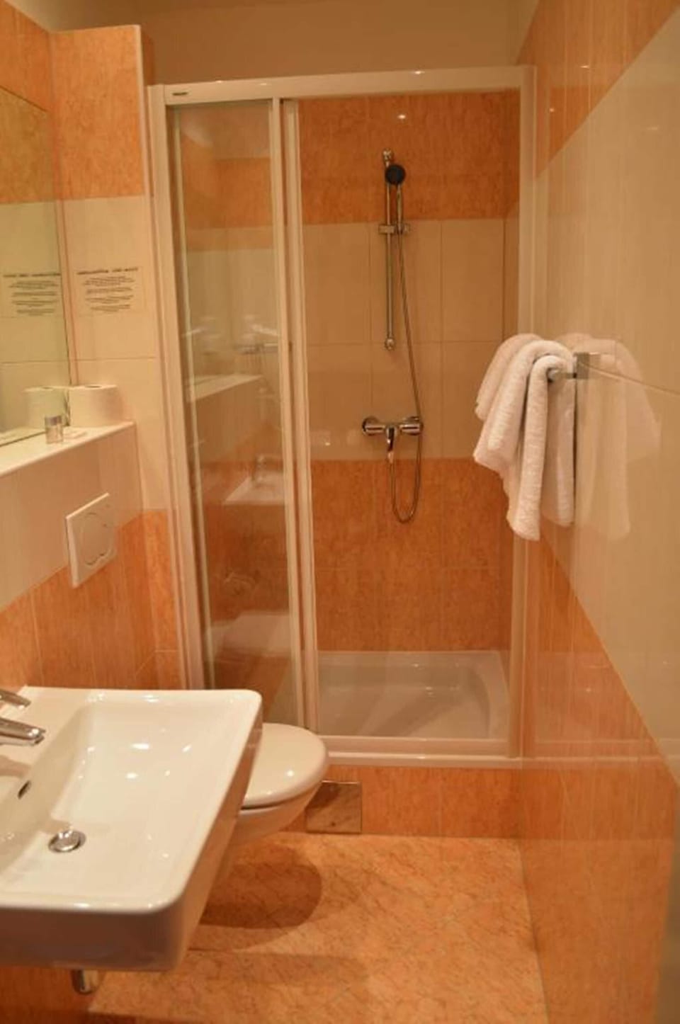 Shower, hair dryer, towels, toilet paper