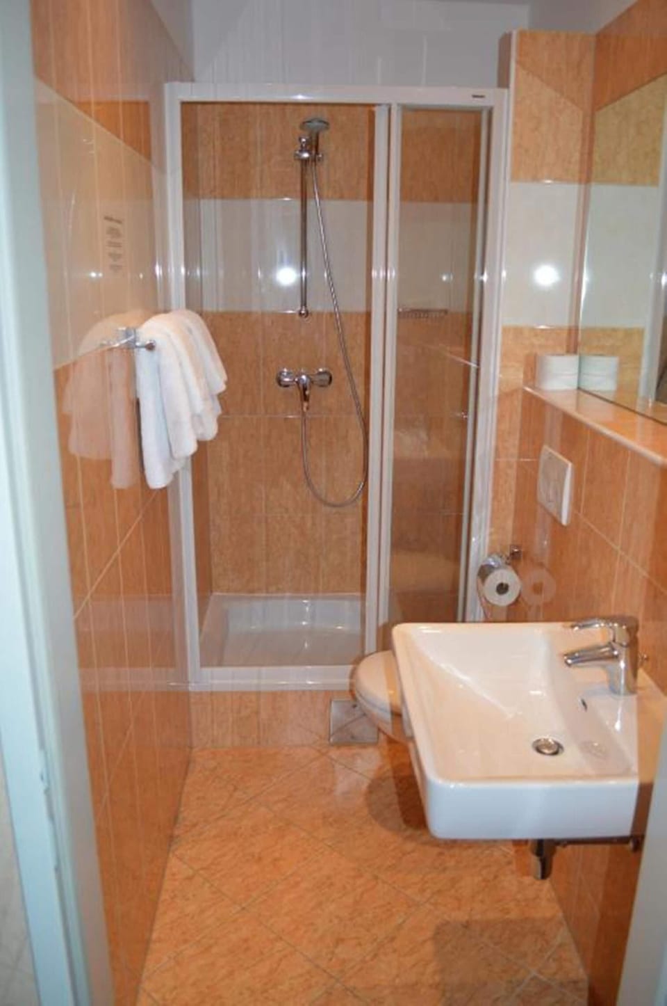 Shower, hair dryer, towels, toilet paper