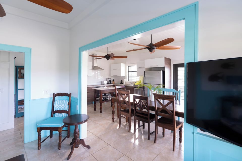 A long view of the kitchen from the snug, adjacent TV room