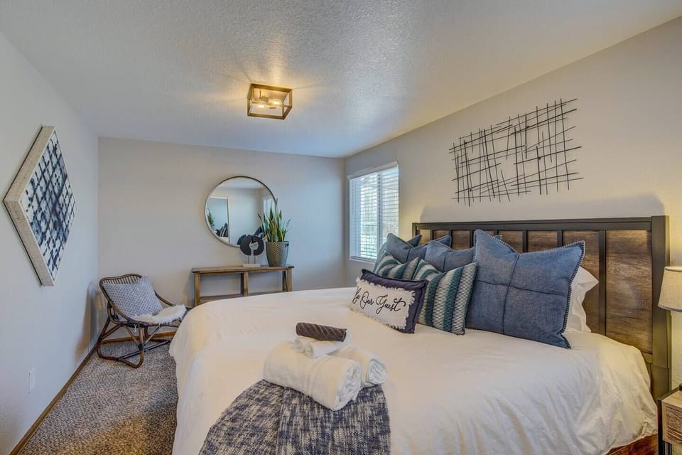 Master Bedroom: Plush bedding and vibrant decor create a serene retreat with mountain views!