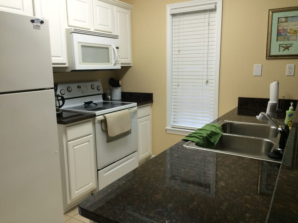 Full kitchen with granite countertops.