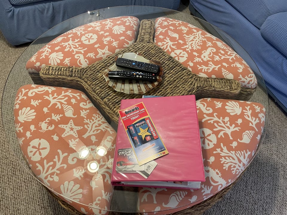 Glass coffee table with pullout stools.