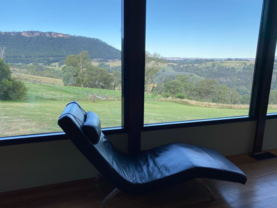 Lazy leather lounge chair with a view over the mountains in the main living area