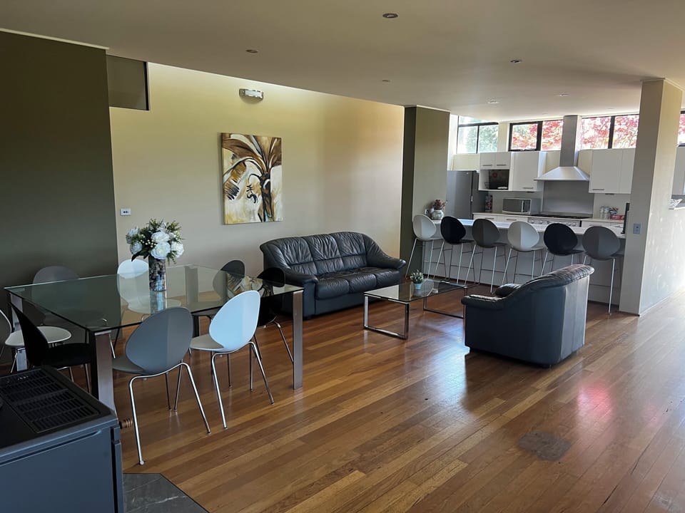 Photo of the second living and dining looking over to the kitchen island bench