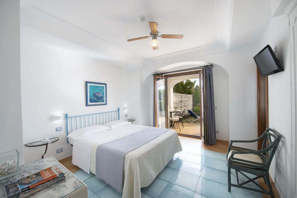 Deluxe Double Room, Patio, Sea View | Individually decorated, individually furnished, desk, blackout drapes