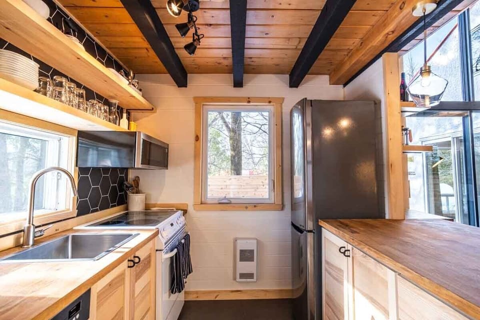 Kitchen is equipped with stove, microwave, and refrigerator