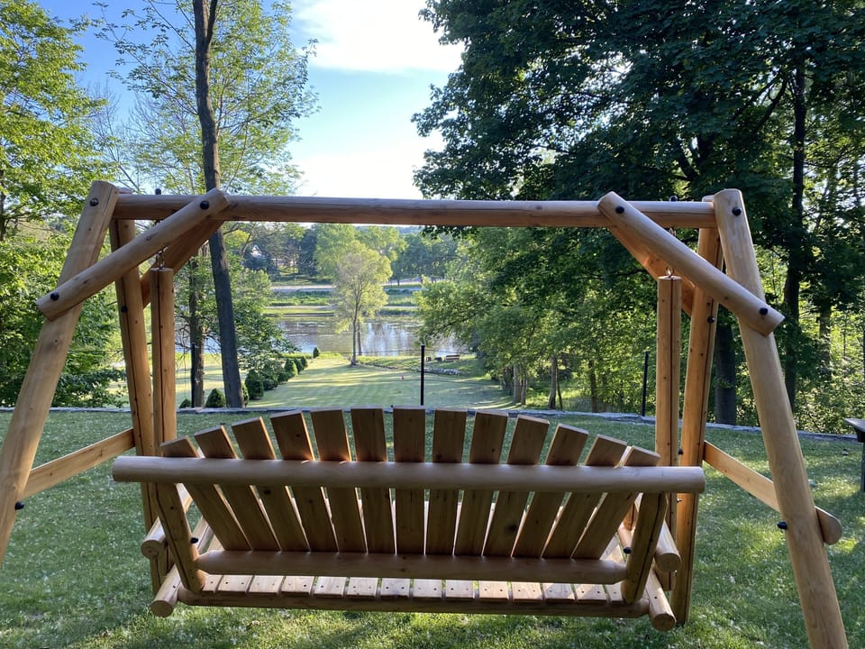 Sit and relax on the swing overlooking the backyard and river. 