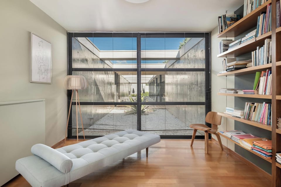 An office with an oak wood desk & a library!