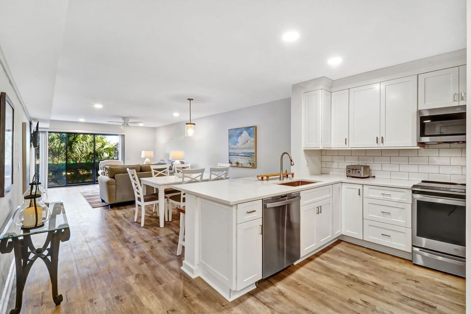 Kitchen - Beautifully renovated open kitchen!  Well stocked with all new stainless appliances.