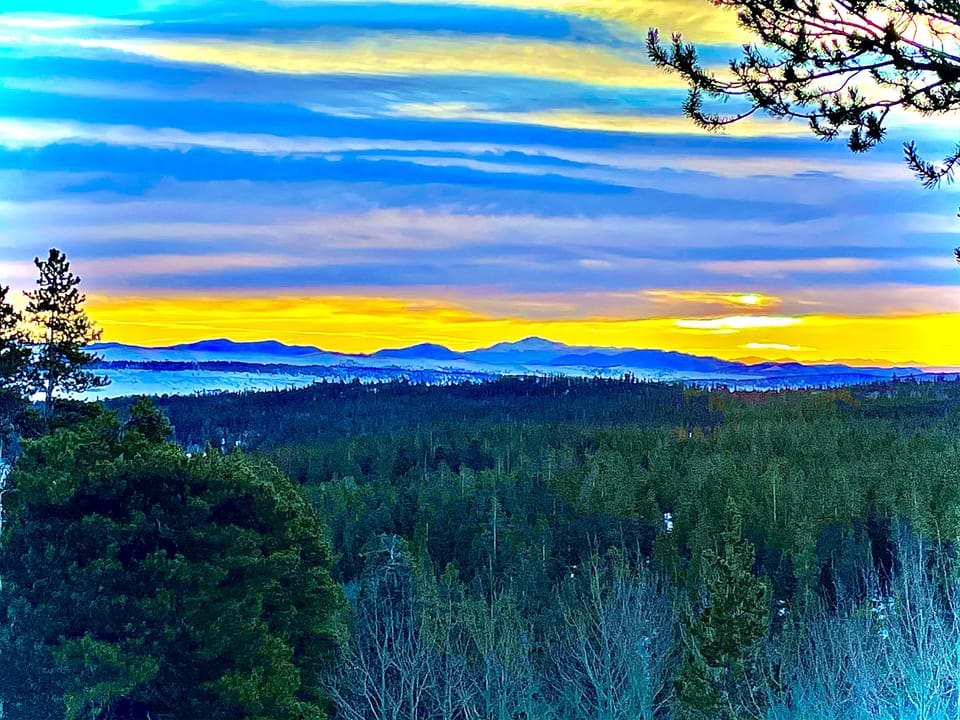 Morning Sunrise at Moose Lodge; Pike’s Peak from deck.