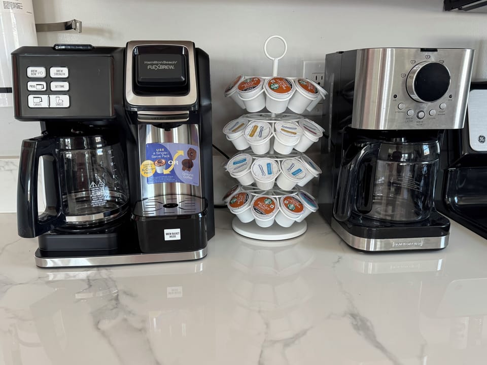 Coffee and tea station with 2 drip coffee makers, k- cup, & electric tea kettle.