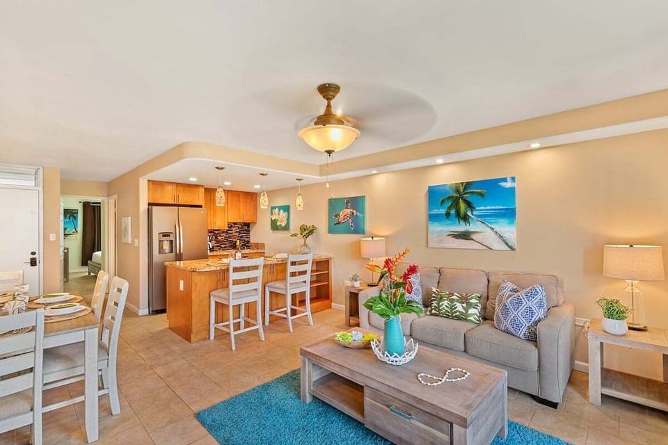 This inviting layout features a cozy lounge, dining space, and a well-equipped kitchen with granite countertops and warm wood cabinetry.