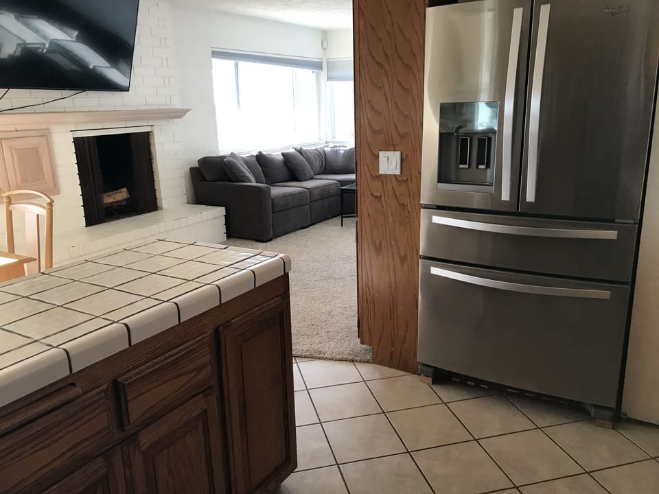 Kitchen has all stainless steel appliances.