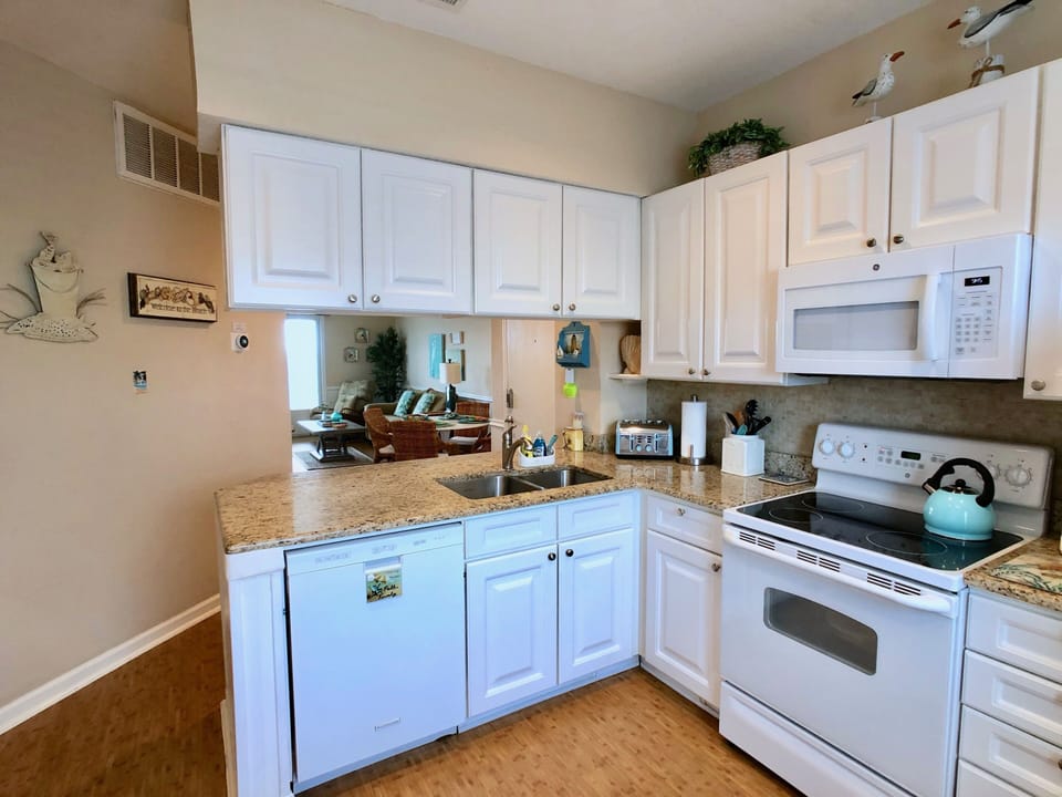 Spacious open-plan kitchen with breakfast bar seating for 2