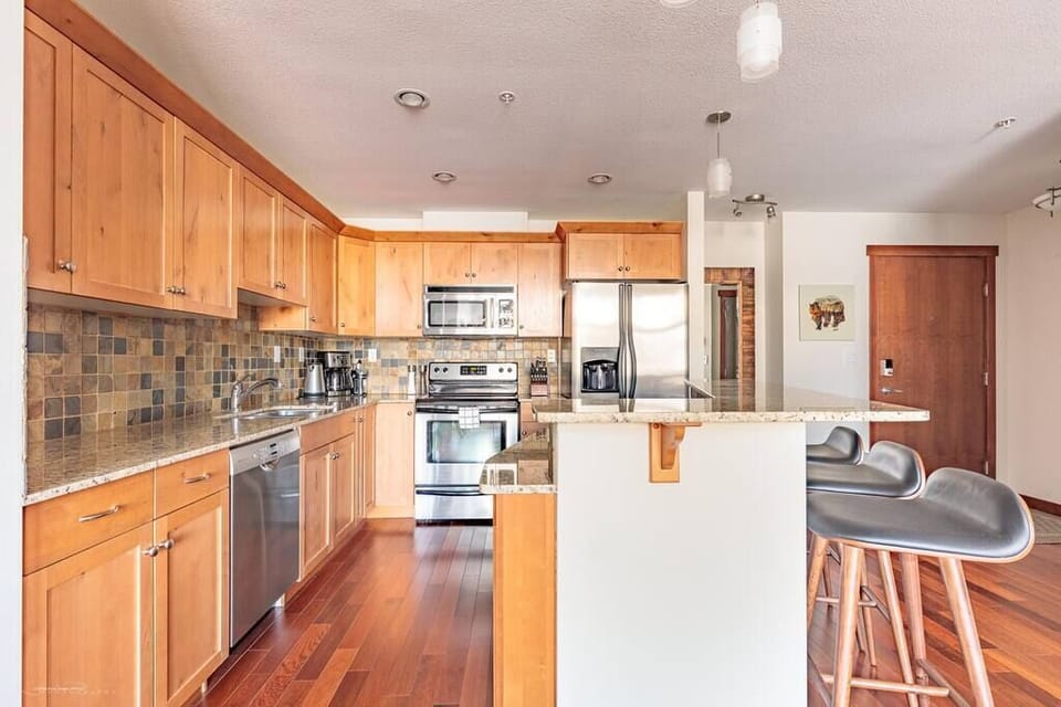Large and incredibly well stocked kitchen with breakfast bar and seating for 3
