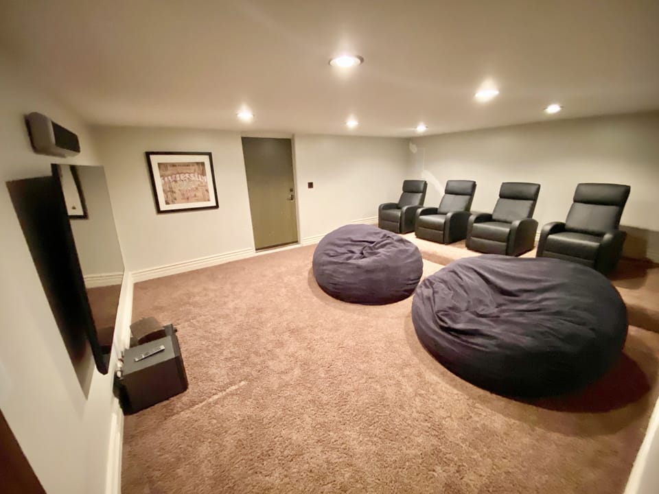 movie theater room with 4 reclining chairs, 2 bean bags, 75 inch smart TV