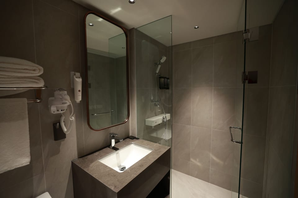 Shower, hair dryer, slippers, towels