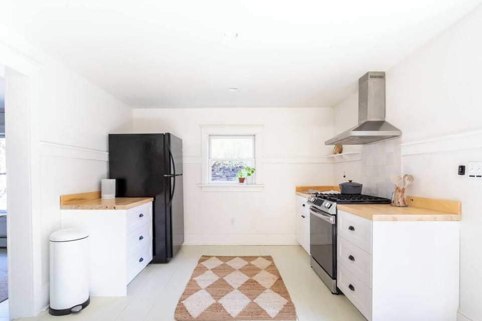 Stocked kitchen with gas range and dishwasher. Walks out to the patio. 
