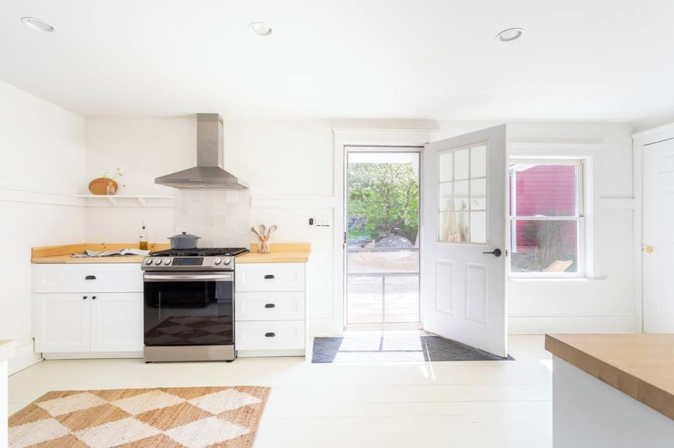 Stocked kitchen with gas range and dishwasher. Walks out to the patio. 