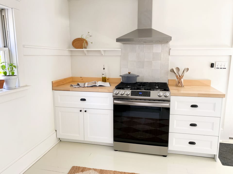 Stocked kitchen with gas range and dishwasher. Walks out to the patio. 