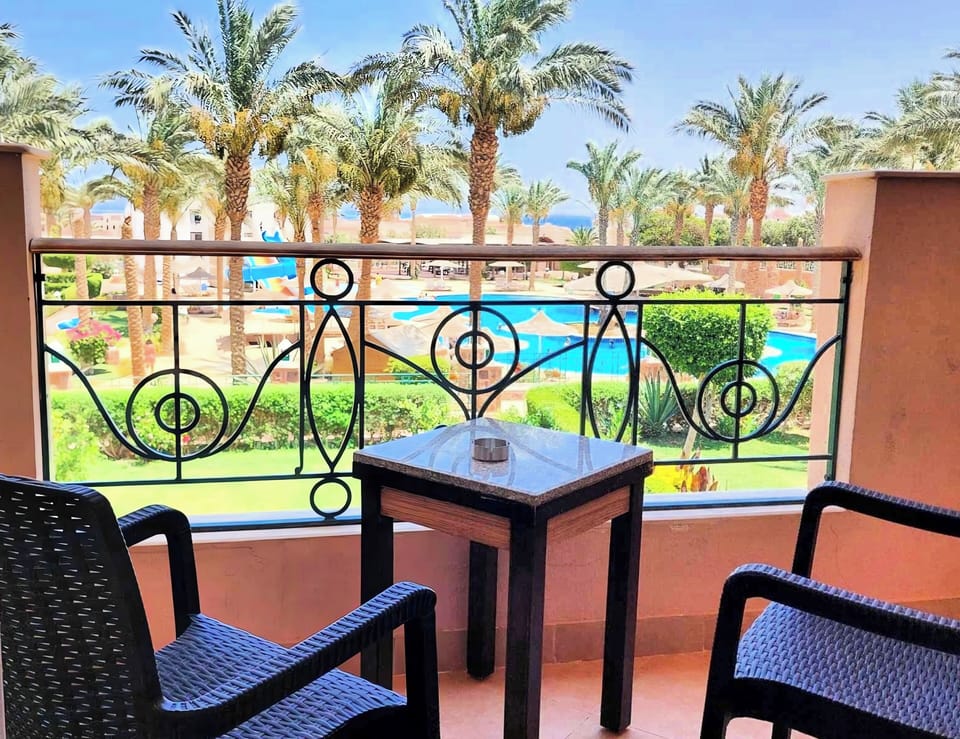 Balcony overlooking garden and swimming pool