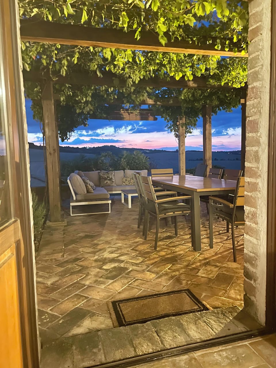 One of four outdoor pergolas; table expands to seat 12