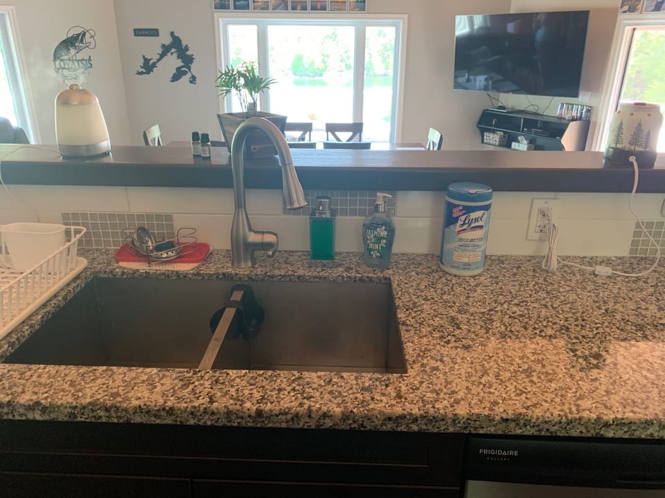 Double sink and cleaning supplies