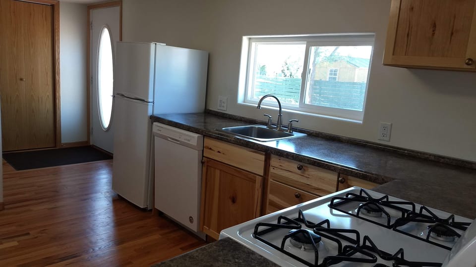 Refrigerator, dishwasher, gas stove, and microwave.