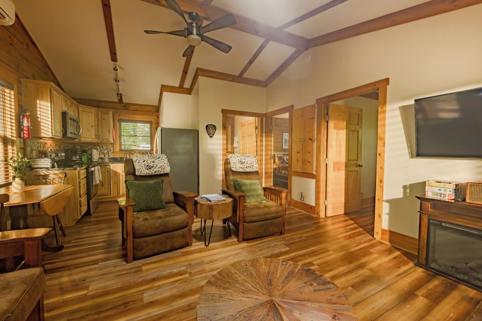 Vaulted ceilings and exposed wood beams set a warm cabin tone from the door. Sink into the recliners by the fireplace, or gather at the table by the granite kitchen. Breakfast turns into an hour of coffee before anyone remembers the lake is waiting. 