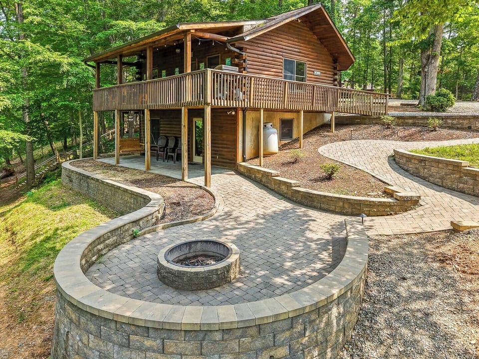 The Retreat at Pine Haven extends the living area with incredible stonework that includes an enormous fire pit and patio. 