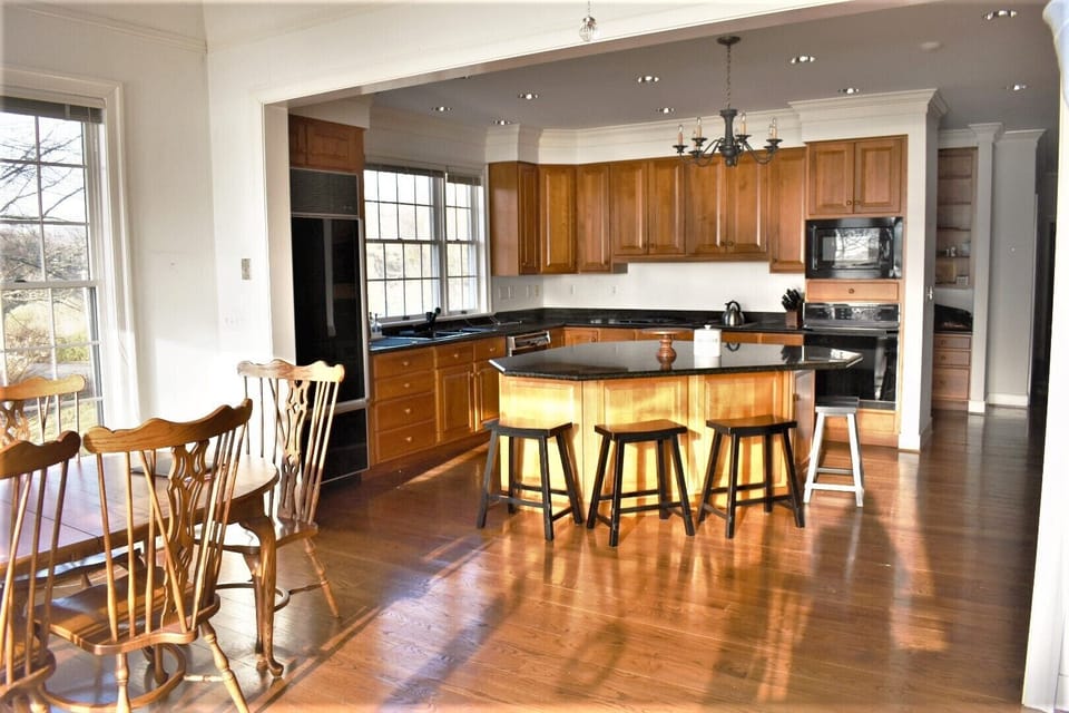 Chefs kitchen with breakfast table and bar stools..  Room for all.