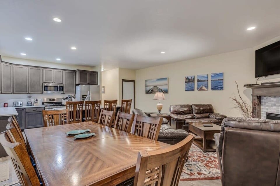 Gather around the spacious dining table for memorable meals, then unwind on plush leather sofas by your cozy fireplace in this elegant open-concept space.