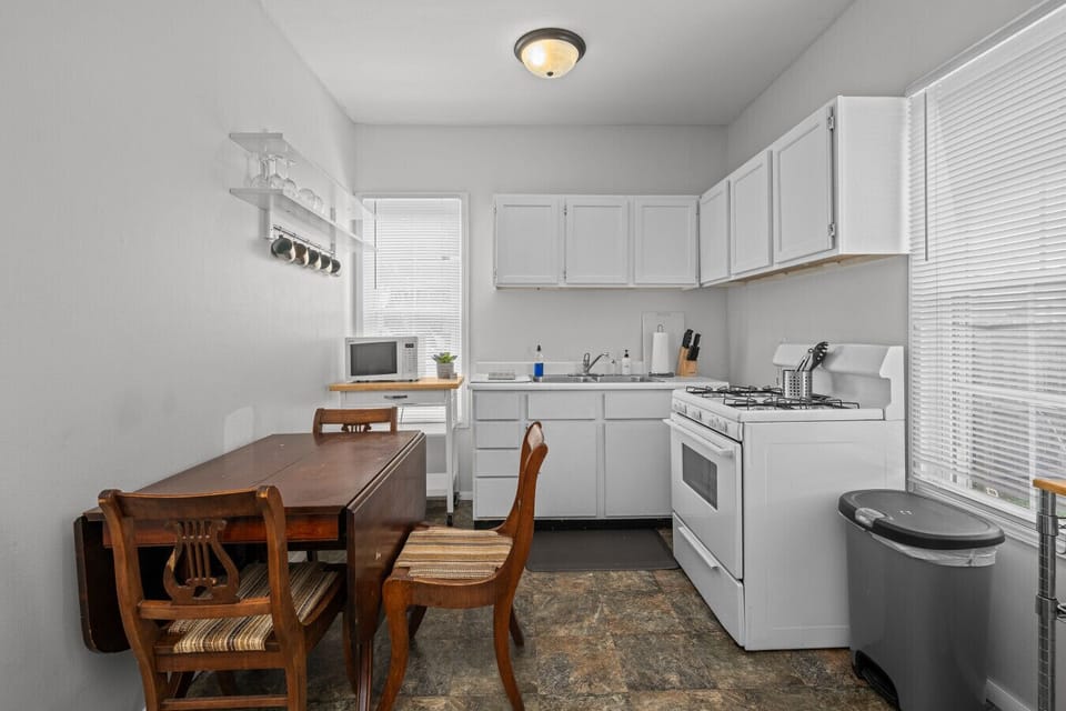Enjoy a bright kitchen setup with a dining table—perfect for breakfast, coffee, or a quick bite before heading out.