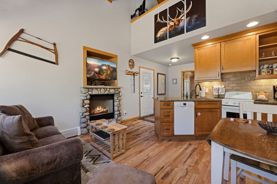 Cozy up by your stone fireplace while preparing meals in the fully equipped kitchen, all surrounded by rustic mountain charm.