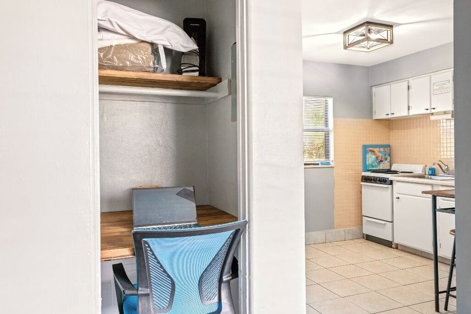 Boutique Beach Retreat Treasure Island work station full kitchen, stove refrigerator, freezer, microwave, coffee maker, kitchen utensils and flatware kitchen table