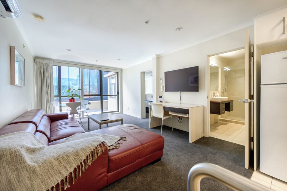 Deluxe Apartment, 1 Bedroom | Living area | 50-inch LCD TV with premium channels, TV, Netflix