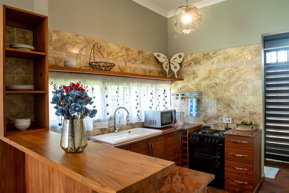 Family Suite, 2 Bedrooms | Private kitchen | Coffee/tea maker, electric kettle, dining tables