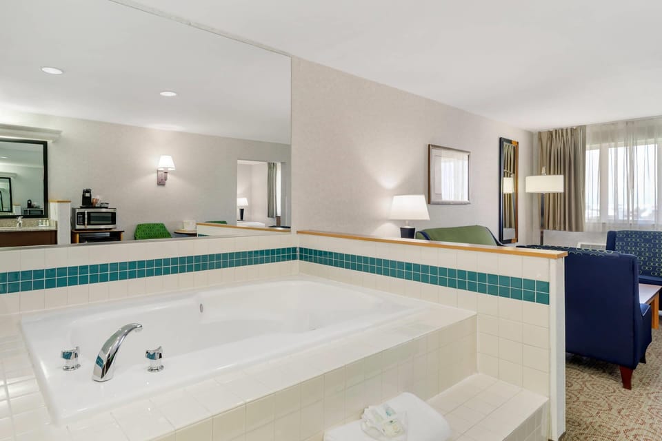 Suite, 1 King Bed, Non Smoking, Jetted Tub | Desk, laptop workspace, blackout drapes, iron/ironing board